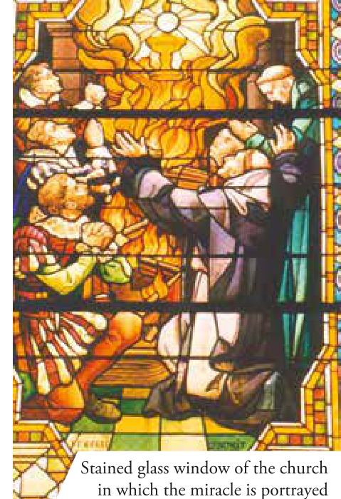Stained glass window of the church in which the miracle is portrayed